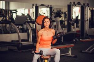 woman with dumbbells in gym