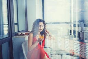 curly woman in red dress photo