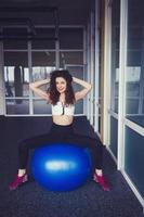 happy curly-haired woman doing exercises photo