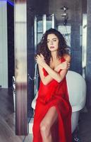 curly model in red dress photo
