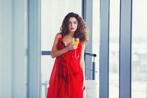 Curly woman drinking juice photo