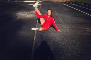 Fit woman stretching her leg photo