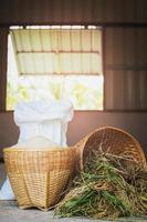 Thai organic raw jasmine rice in bamboo basket. photo