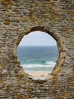 looking at the lake through a hole in the wall