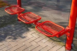 red metal seats at bus stop photo