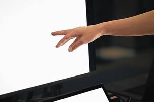 Woman working on computer with hand pointing at desktop screen. photo