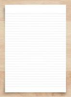 White paper sheet isolated on wood background with clipping path. photo