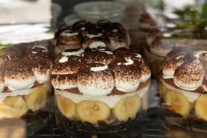 Traditional Banoffee dessert with caramel, banana, and whipped cream sale in cafe. photo