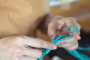 Woman holding crochet needle. Crafts and hobbies.