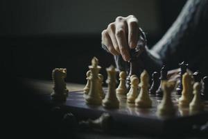 Close up shot hand of young woman playing chess for business challenge competition winner concept photo