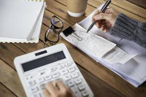 Business woman working at office with documents on his desk , Counting financial data and examines the financial results photo