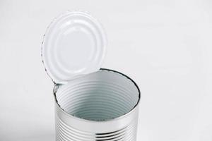 Empty open tin can on a white background photo