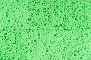 Green sponges for cleaning as a background texture photo