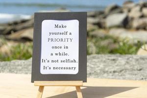 Motivational and Inspirational quote on a notepad with blurred beach background photo