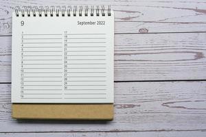 September planner and organizer 2022 calendar on wooden desk. Directly above. photo