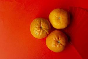 Chinese New Year Concept - Mandarin oranges and red packet photo