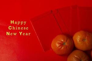 Chinese New Year Concept - Mandarin oranges and red packet photo