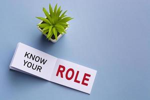Text on notepad with potted plant on blue background. photo