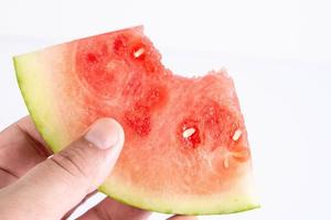 Sliced Watermelon in the hand above white background photo