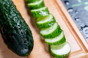 Cucumber sliced on a wooden board. photo