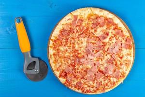 Baked Pizza with Ham and pizza round knife photo