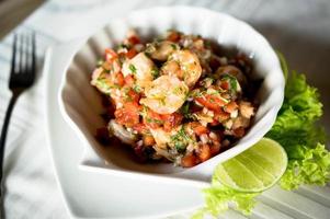 Colorful ceviche in a sea shell shaped plate photo