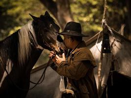 Cowboy kiss the horse with love photo