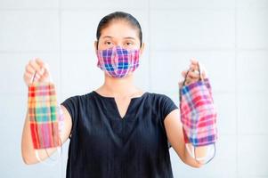 Asian women have to use a face mask to protect against dust pollution and prevent infection from viruses that spread in the air photo