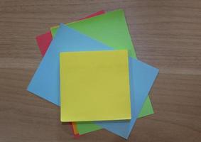 Color notepad on wooden desk. Flat lay, Directly above view photo