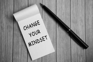 Change your mindset text on notepad and a pen on a wooden desk photo