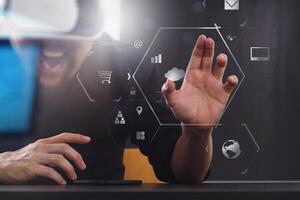 businessman wearing virtual reality goggles in modern office with mobile phone using with VR headset with screen icon diagram photo