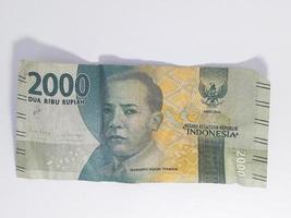 Indonesian money, 2000 banknotes isolated on a white background photo