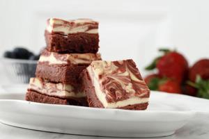 brownie de queso crema de chocolate de terciopelo rojo con motivo de remolino en la parte superior, delicioso pastel casero de dos capas. foto
