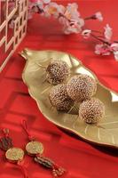 Onde-Onde Jajan pasar from Indonesia, COncept Red Chinese New Year. Chinese Influenced Snack made from Sesame Balls with Mung Bean Paste photo