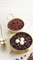 Korean Food Patjuk or Red Bean Porridge Topped with Round Rice Cake, Eat at Winter Solstice Festival photo