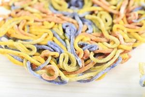Multicolored Rainbow Dry Vegetarian Pasta or Asian Noodle, Natural Color from Vegetable, Beet Roots, Kale, Purple Butterfly Pea, and Turmeric. photo