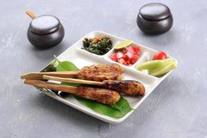 Delicious Traditional Indonesian Balinese Culinary, Sate Lilit, Minced Seafood Satay Made from Tuna Fish and Other Spicy ingredients. Accompanied with Sambal Matah, photo