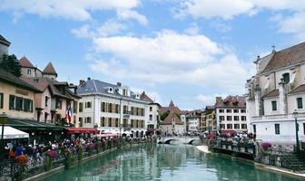 the view of city canal with medieval buildings in Annecy Old Town, Restaurant near the River Thou in Old Town,The building looks great in middle of a large city. photo