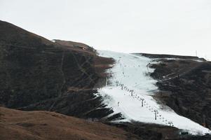 Ski slope with artificial snow only photo