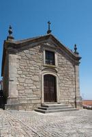 Front view of Chapel of the Lord of Mercy, beautiful religious building made of stone. Castelo Novo, Portugal