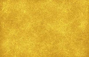 Gold foil background with light reflections. Golden textured wall photo
