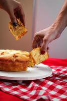 Cake sliced with hands photo