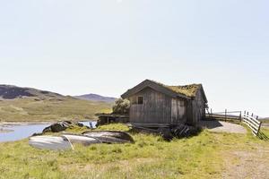 Idyllic hut with fishing boats near vavatn lake Hemsedal, Norway.