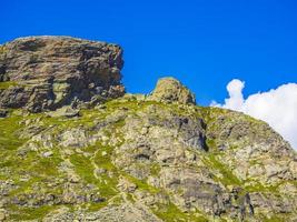 Veslehodn Veslehorn mountain peak rocks cliffs Hydnefossen waterfall Hemsedal Norway. photo