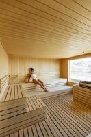 Young woman relaxing in the sauna photo