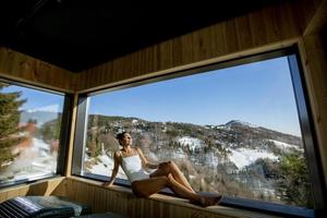 Young woman relaxing in the spa at winter season photo