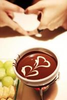 Hot chocolate with heart shape of white cream photo