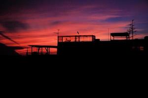 Beautiful colorful of sunset with silhouette of city buildings. photo