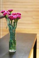 Pink Gerbera or Barberton daisy flowers in the glass vase photo