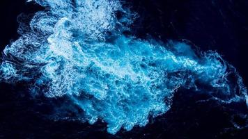 Aerial shot of white water caused by underwater rocks